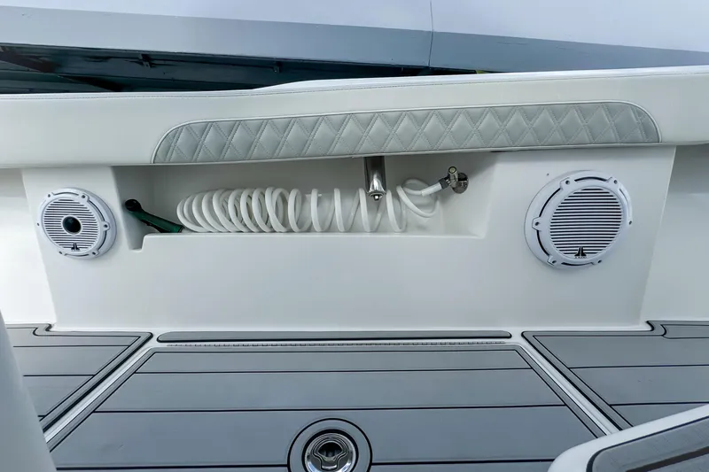 Slide: The Image of 2023 Front Runner 36 Center Console boat interior with speakers and coiled hose. - 40