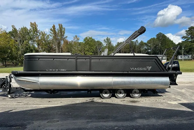 The Image of 2025 Viaggio Lago V-U pontoon boat on trailer, parked outdoors. - 1