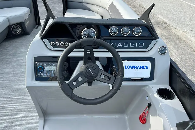 Slide: The Image of Viaggio Lago V-U 2025 boat dashboard with steering wheel and navigation controls. - 10