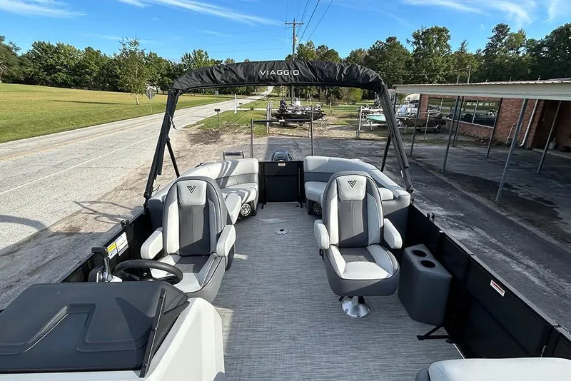 Slide: The Image of 2025 Viaggio Lago V-U boat with modern seating and steering, parked on a roadside. - 20