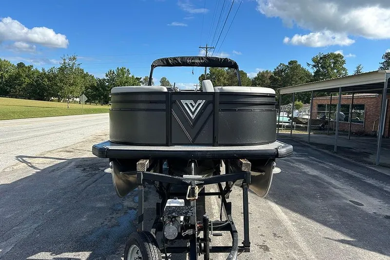Slide: The Image of 2025 Viaggio Lago V-U pontoon boat on trailer, parked outdoors under blue sky. - 3