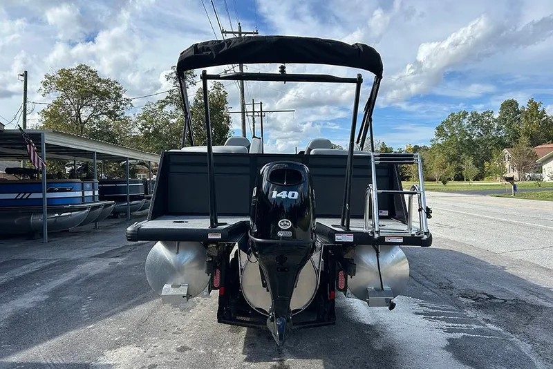 Slide: The Image of 2025 Viaggio Lago V-U pontoon boat with 140 HP engine, parked outdoors. - 7