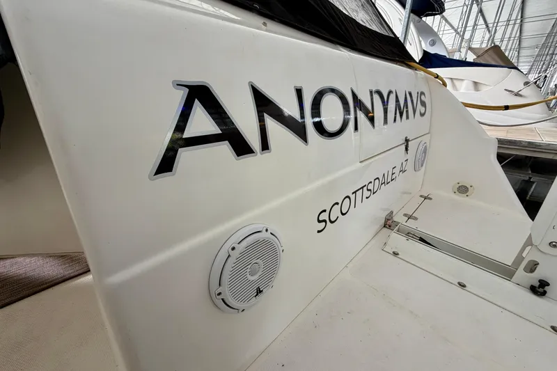 Slide: The Image of Interior of 1999 Wellcraft 45 Excalibur yacht with white seating and carpeted floor. - 10