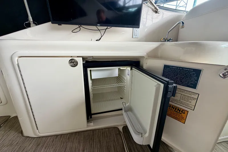 Slide: The Image of 1999 Wellcraft 45 Excalibur interior with white leather seating and carpeted flooring. - 13