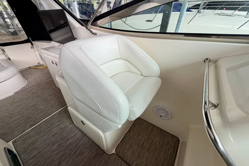 Slide: The Image of 1999 Wellcraft 45 Excalibur boat interior with white seating and steering wheel. - 16