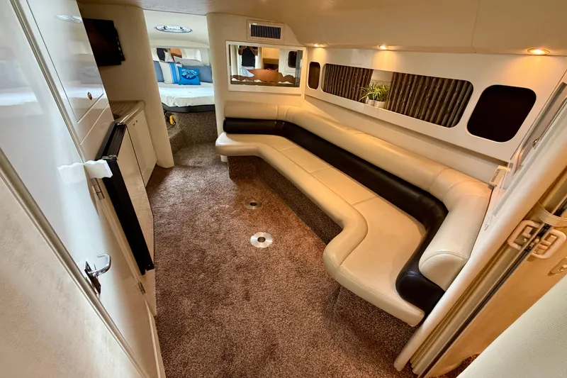 Slide: The Image of 1999 Wellcraft 45 Excalibur interior with beige and black leather seating, carpeted floor. - 26