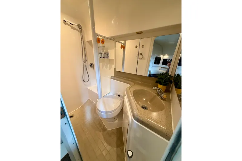 Slide: The Image of Bathroom interior of 1999 Wellcraft 45 Excalibur yacht, featuring shower and toilet. - 31
