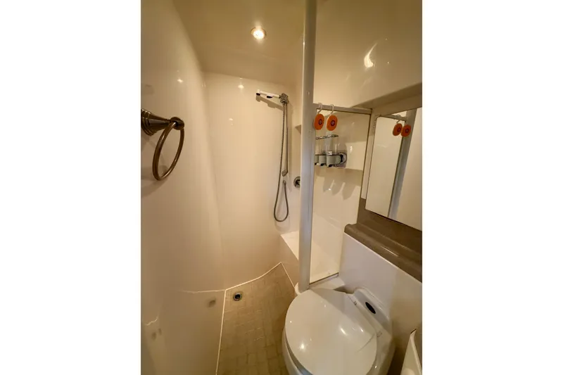 Slide: The Image of Cozy cabin interior of 1999 Wellcraft 45 Excalibur with bed and porthole windows. - 32