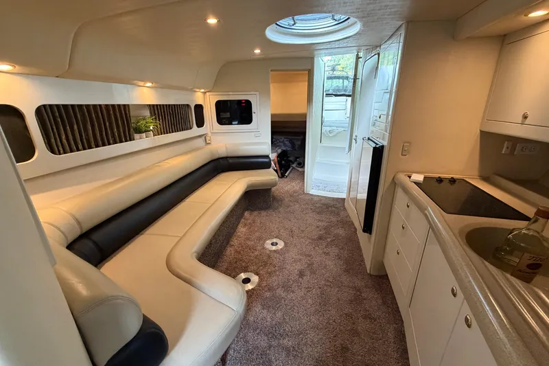 Slide: The Image of 1999 Wellcraft 45 Excalibur cabin interior with patterned seating and carpeted floor. - 36