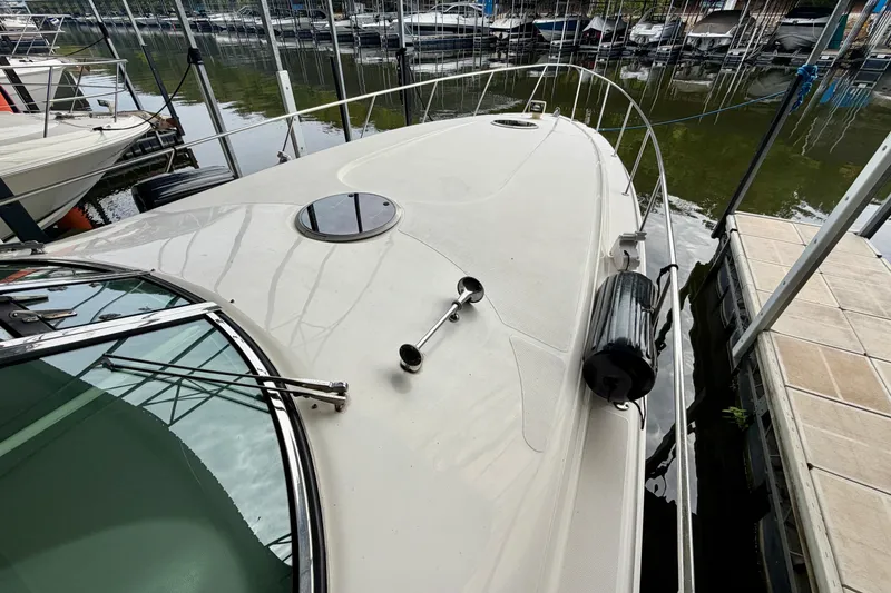 Slide: The Image of Bow of a 1999 Wellcraft 45 Excalibur boat on calm water. - 5