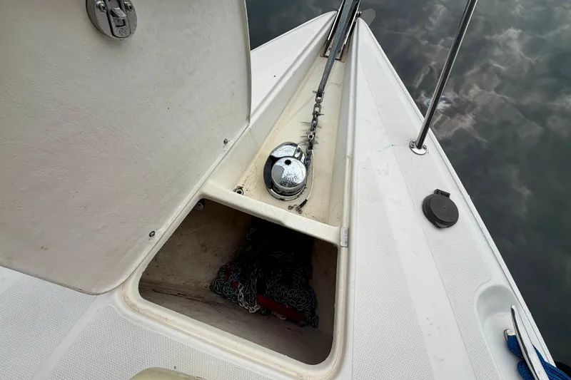 Slide: The Image of 1999 Wellcraft 45 Excalibur boat docked, showcasing sleek white deck design. - 7