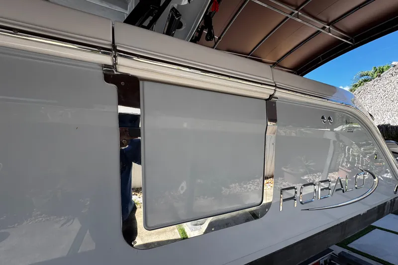 Slide: The Image of 2019 Robalo R272 Center Console boat side view with logo and sleek design. - 11