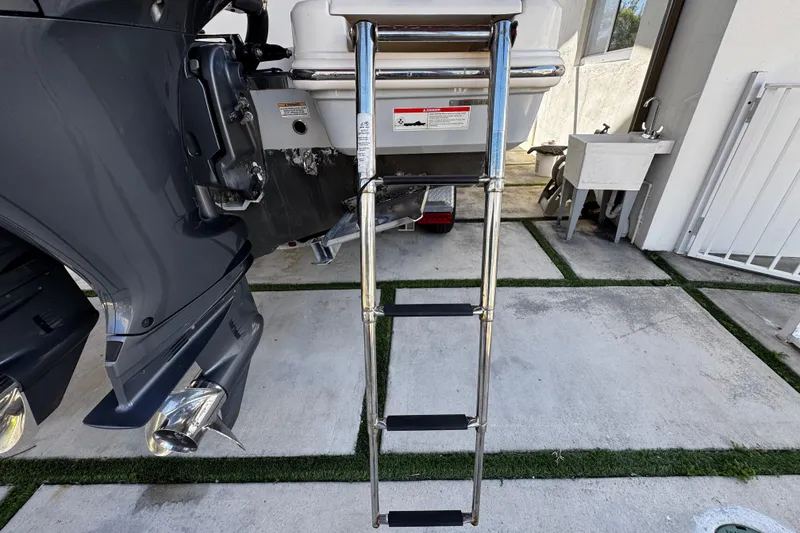 Slide: The Image of 2019 Robalo R272 Center Console boat with stainless steel swim ladder. - 18