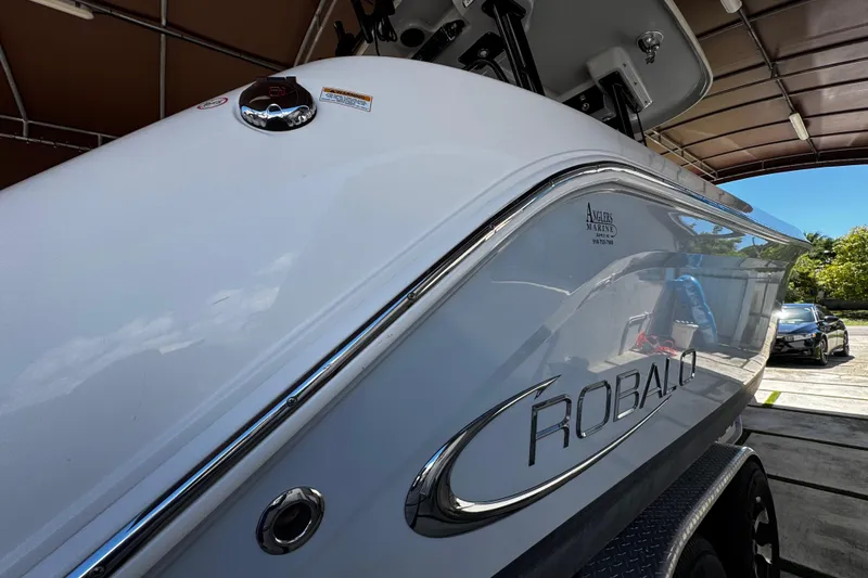 Slide: The Image of 2019 Robalo R272 Center Console boat in a covered storage area. - 19