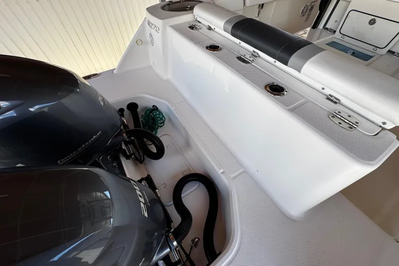 Slide: The Image of 2019 Robalo R272 Center Console boat with dual outboard engines and seating area. - 20
