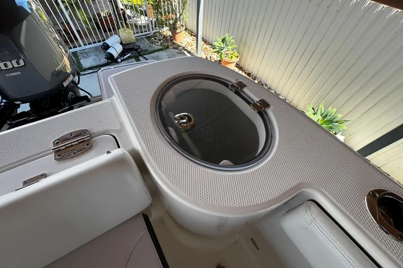 Slide: The Image of 2019 Robalo R272 Center Console boat interior with Yamaha engine and storage compartment. - 23
