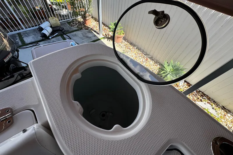 Slide: The Image of 2019 Robalo R272 Center Console boat with open storage compartment. - 24