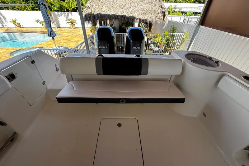 Slide: The Image of 2019 Robalo R272 Center Console boat interior with seating and dual engines. - 29
