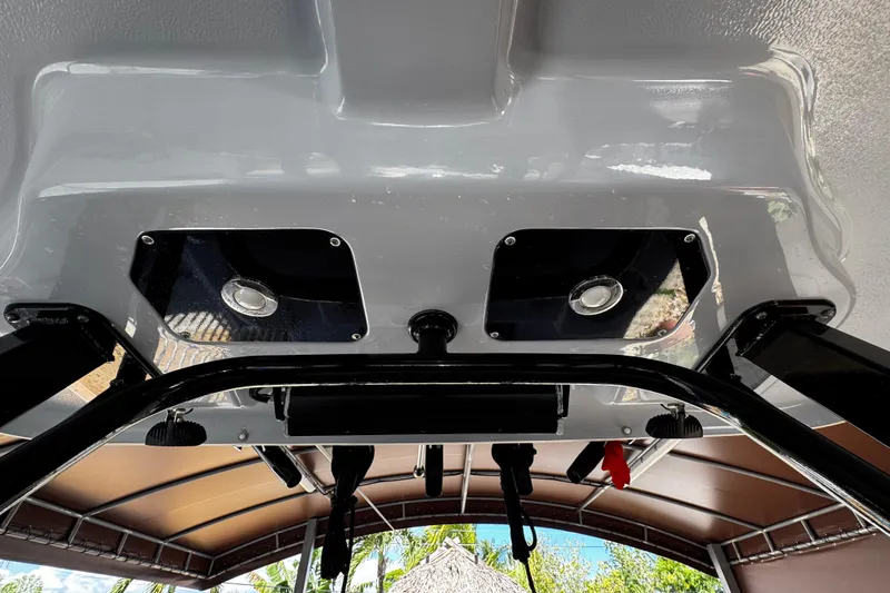 Slide: The Image of 2019 Robalo R272 Center Console boat interior with overhead view of speakers and canopy. - 30