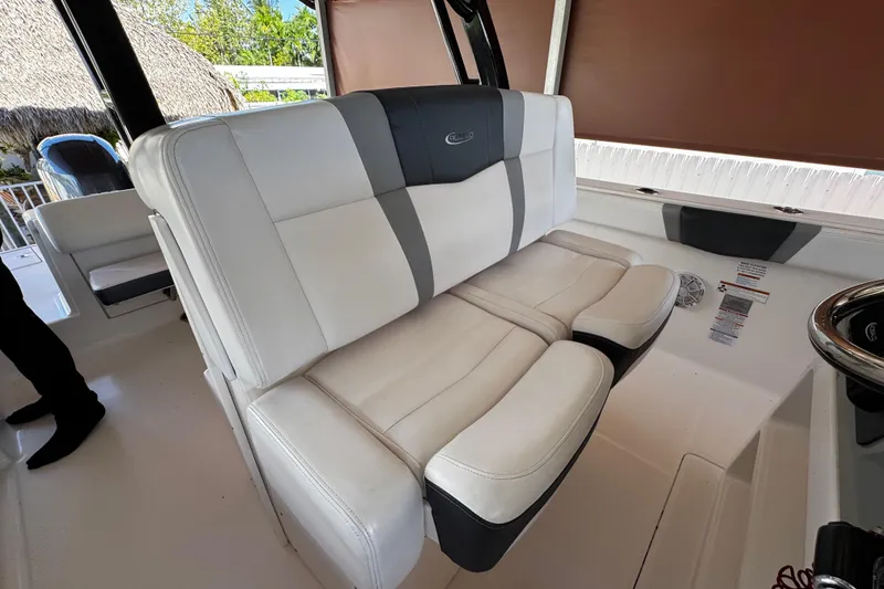 Slide: The Image of 2019 Robalo R272 Center Console boat with white and gray seating. - 32