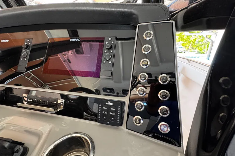 Slide: The Image of 2019 Robalo R272 Center Console dashboard with Simrad displays and control panel. - 35