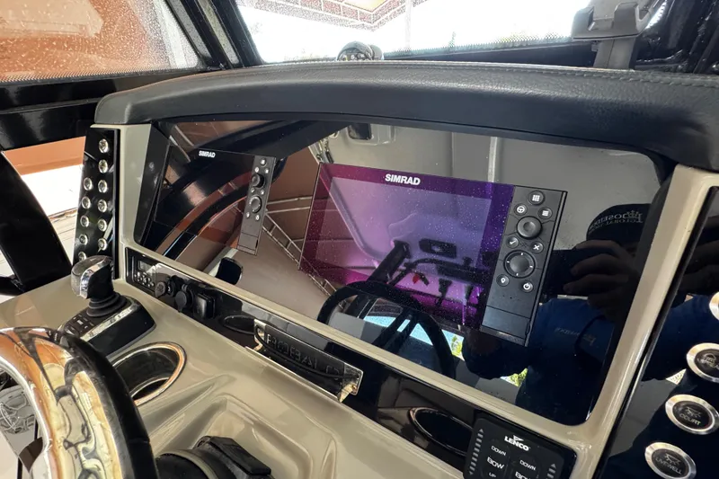 Slide: The Image of 2019 Robalo R272 Center Console dashboard with Simrad navigation system. - 36