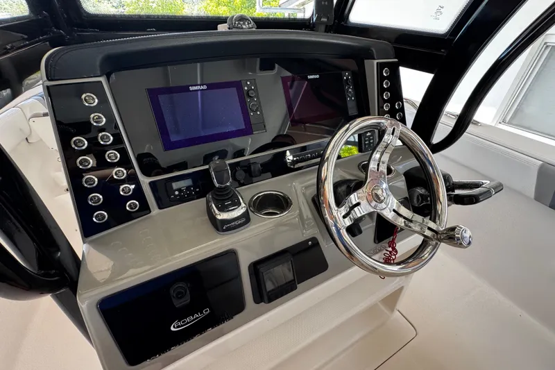 Slide: The Image of 2019 Robalo R272 Center Console dashboard with steering wheel and navigation controls. - 39