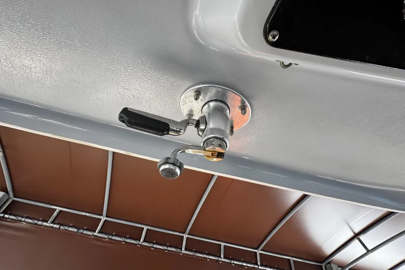 Slide: The Image of 2019 Robalo R272 Center Console boat detail, featuring a mounted handle mechanism. - 41