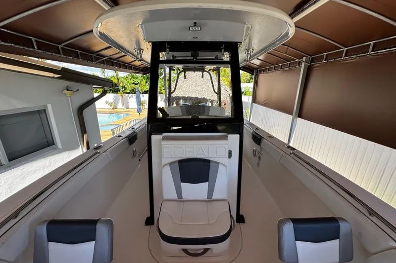 Slide: The Image of 2019 Robalo R272 Center Console boat interior with seating and console under canopy. - 46