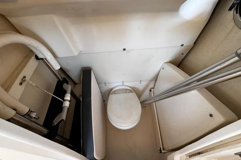Slide: The Image of 2019 Robalo R272 Center Console boat interior with compact marine toilet setup. - 51