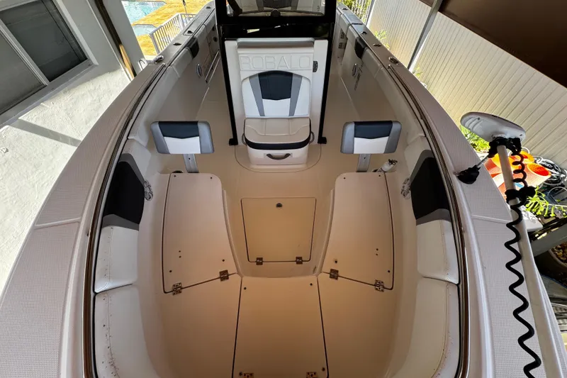 Slide: The Image of 2019 Robalo R272 Center Console boat interior with seating and storage compartments. - 55