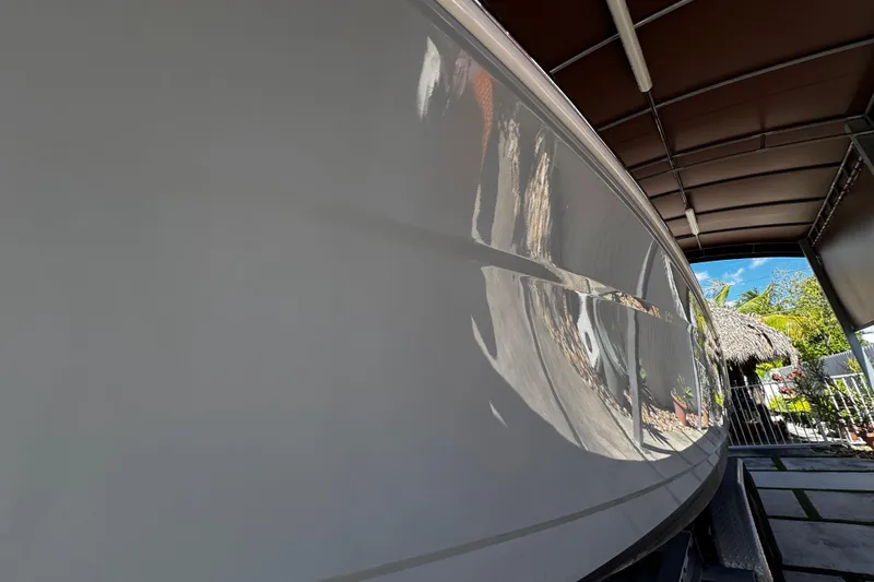 Slide: The Image of 2019 Robalo R272 Center Console boat hull reflecting surroundings in a covered area. - 9