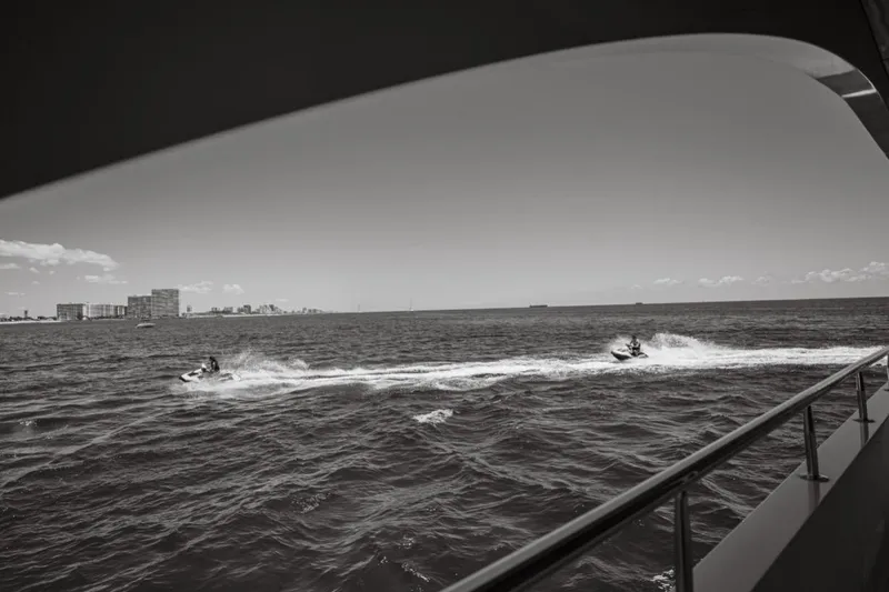 Slide: The Image of Luxury yacht Intermarine RPH 95 with jet skis and paddleboards on the ocean, 2001 model. - 21