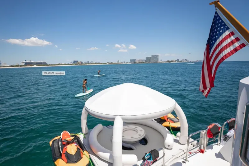 Slide: The Image of Jet skis on clear blue water near an Intermarine RPH 95 yacht, 2001 model. - 23