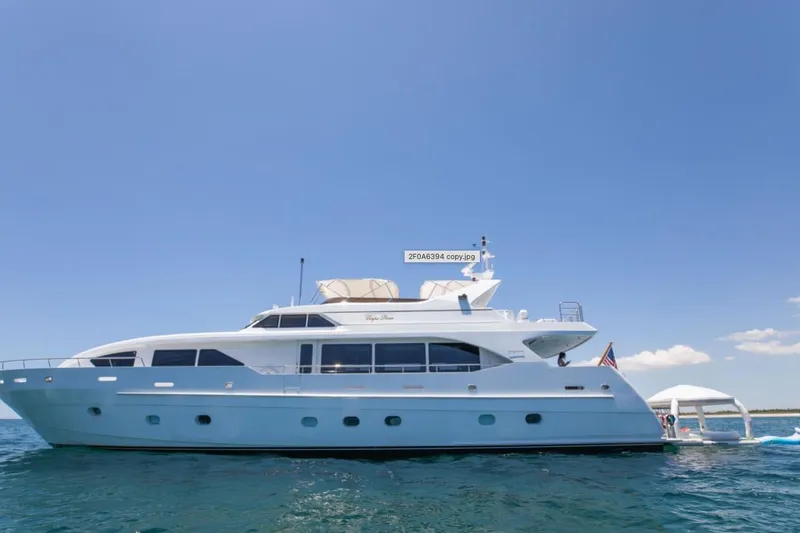 Slide: The Image of Intermarine RPH 95 yacht with jet ski and paddleboards on open water, 2001 model. - 26