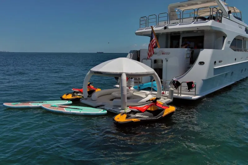 Slide: The Image of Luxurious 2001 Intermarine RPH 95 yacht deck with seating and bar, overlooking serene waters. - 49