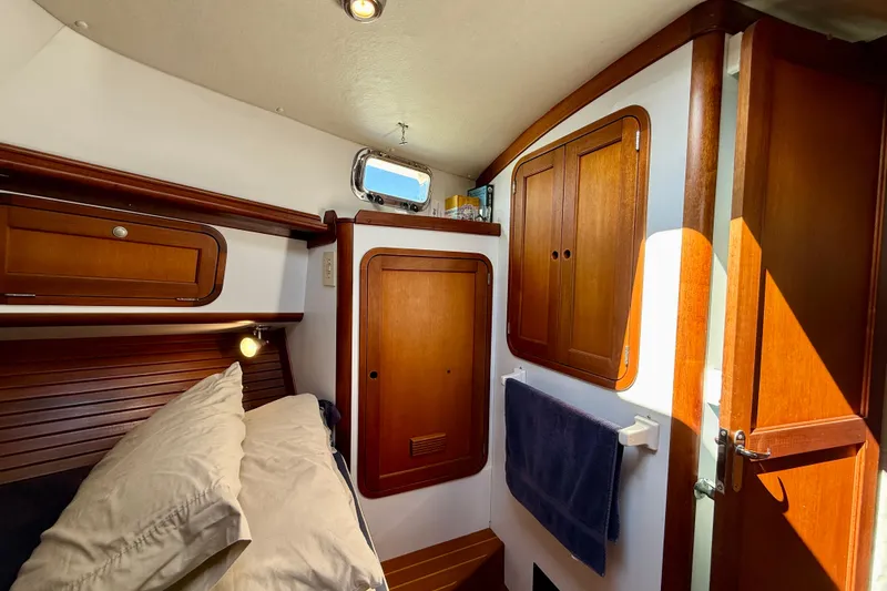 Slide: The Image of Cozy cabin interior of 1999 Legacy 40 yacht with wooden cabinetry and porthole. - 12