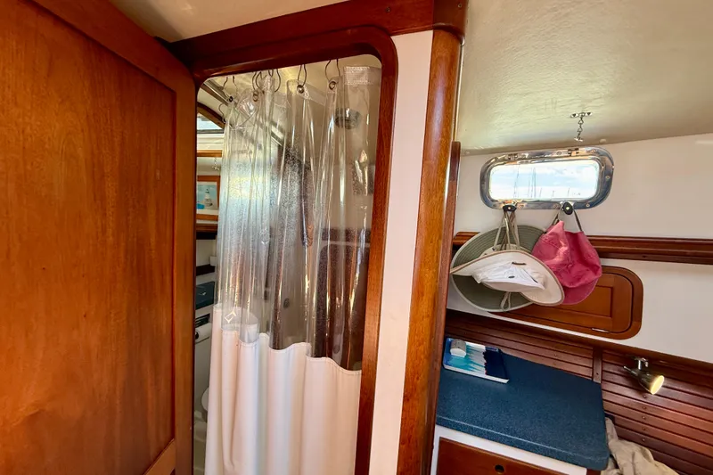 Slide: The Image of Interior of 1999 Legacy 40 yacht with shower and cozy cabin space. - 14