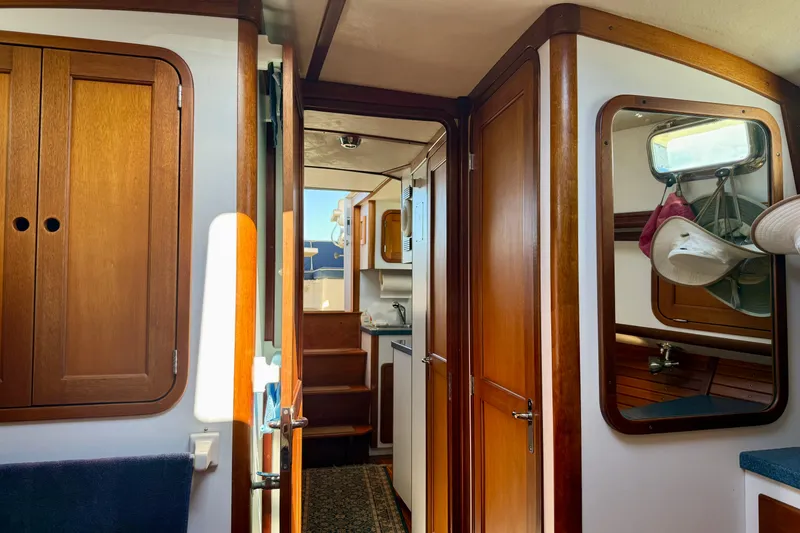 Slide: The Image of Interior of 1999 Legacy 40 boat with wooden cabinetry and nautical decor. - 15