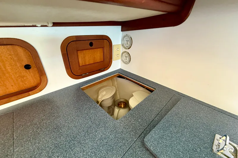Slide: The Image of Interior of 1999 Legacy 40 boat with storage compartments and gauges. - 25