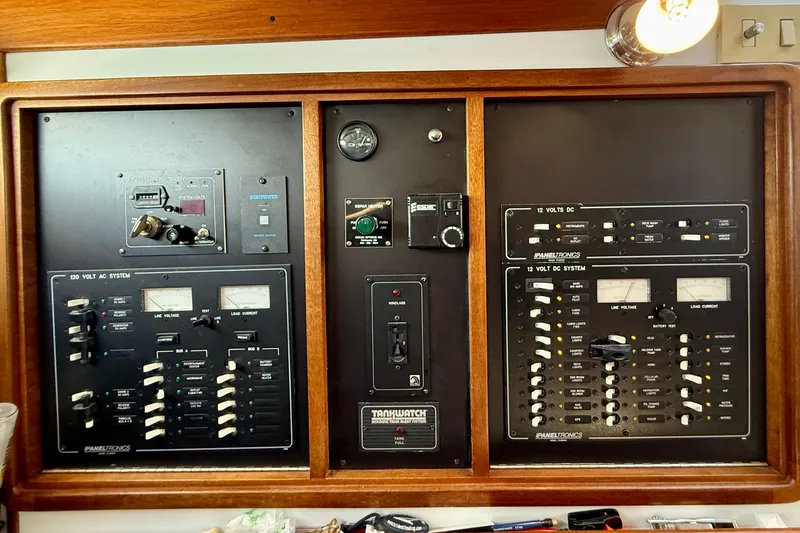 Slide: The Image of Electrical control panel on a 1999 Legacy 40 boat, featuring AC and DC systems. - 32