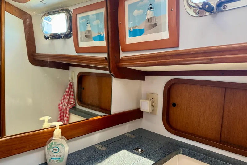 Slide: The Image of Bathroom interior of 1999 Legacy 40 boat with mirror, artwork, and hand soap. - 36
