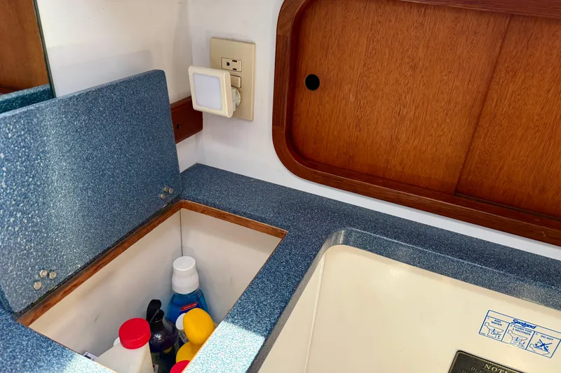 Slide: The Image of Interior of 1999 Legacy 40 boat with storage compartment and wooden paneling. - 37