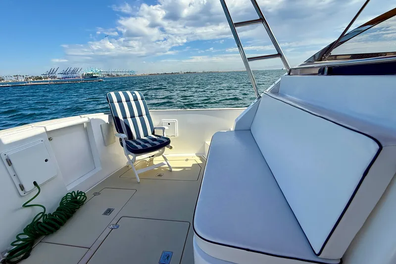 Slide: The Image of Cozy seating on 1999 Legacy 40 boat with ocean view and clear skies. - 42