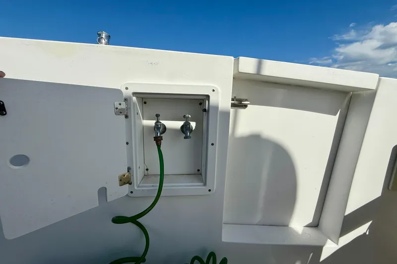 Slide: The Image of Boat deck with open hatch and green hose, Legacy 40, 1999 model. - 44