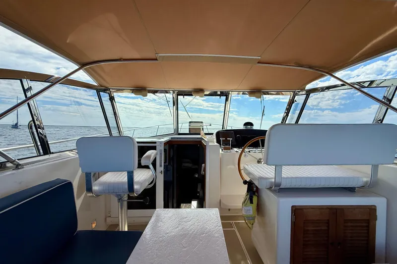 Slide: The Image of Interior view of a 1999 Legacy 40 yacht with seating and steering wheel. - 48