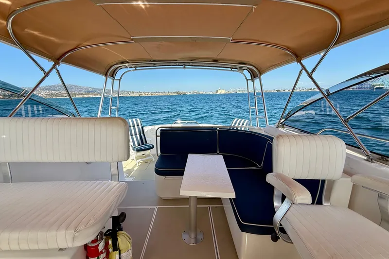 Slide: The Image of Interior view of a 1999 Legacy 40 boat with seating and ocean backdrop. - 50