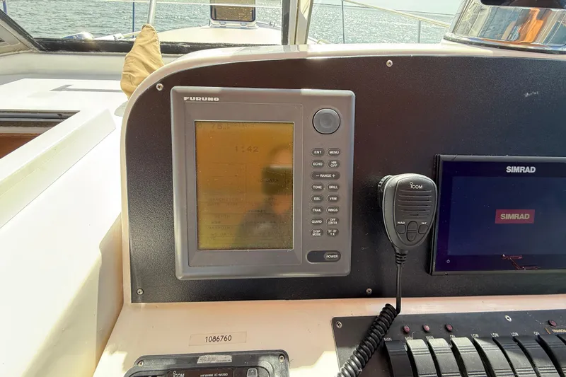 Slide: The Image of Boat dashboard with Furuno and Simrad navigation systems, Legacy 40, 1999 model. - 55