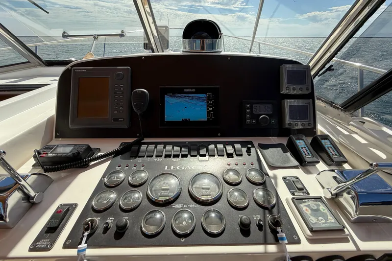 Slide: The Image of Control panel of a 1999 Legacy 40 boat with navigation instruments and ocean view. - 59