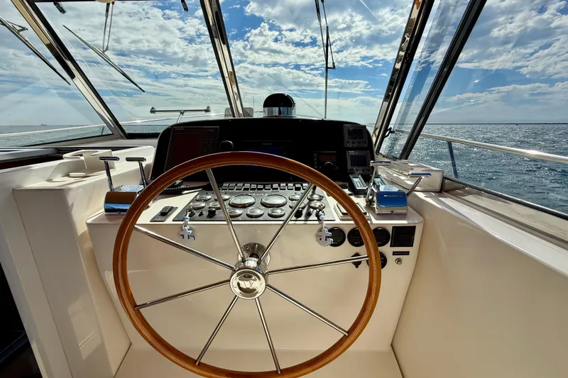 Slide: The Image of Cockpit of 1999 Legacy 40 yacht with wooden steering wheel and ocean view. - 60